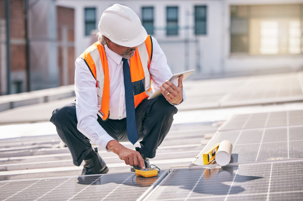 Tablet, solar panels and engineering man on rooftop, city and urban development, sustainability or